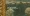 A close-up of an impressionist painting in a golden frame.